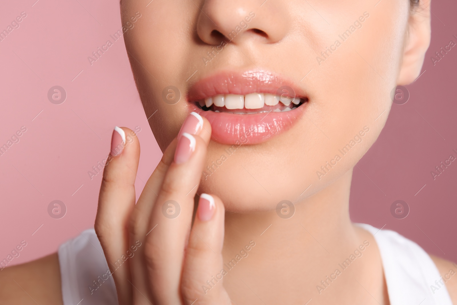 Photo of Young woman with sexy lips on color background, closeup