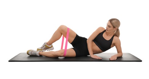 Photo of Woman exercising with elastic resistance band on fitness mat against white background