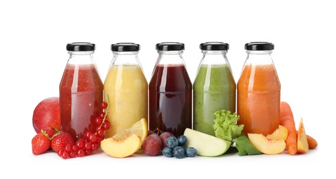 Photo of Bottles of delicious juices and fresh fruits on white background