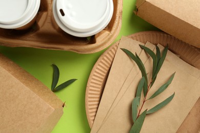 Flat lay composition with eco friendly products on light green background