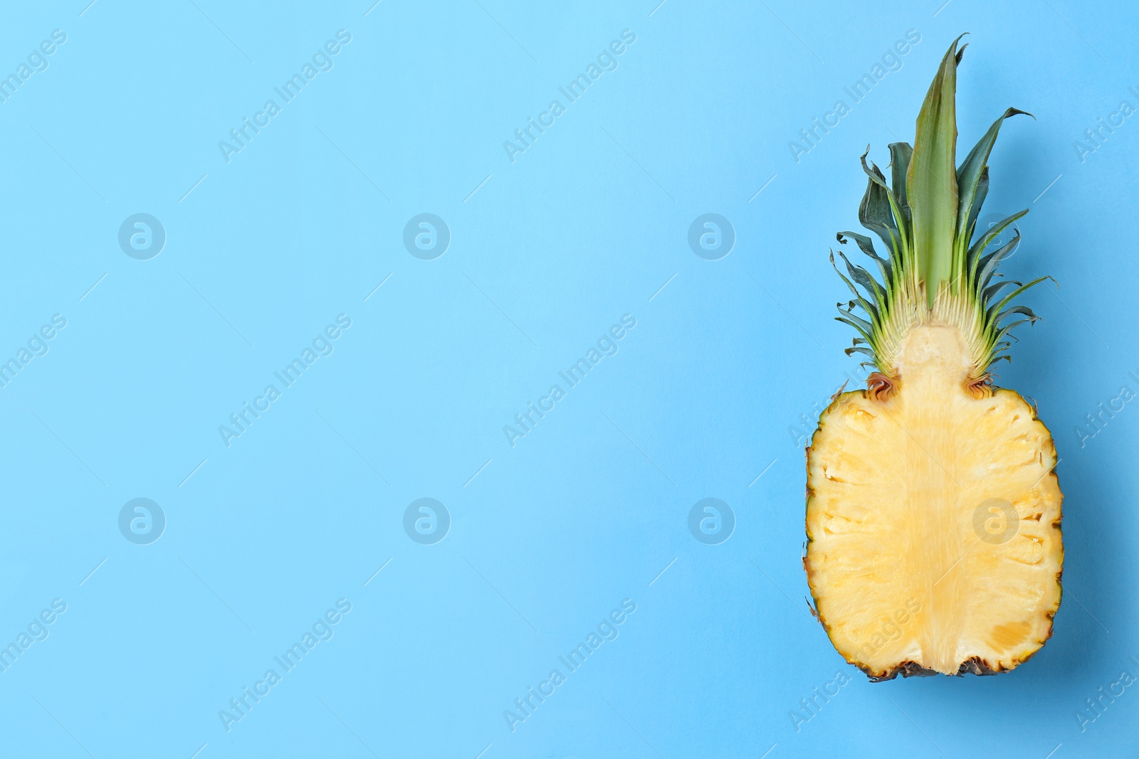 Photo of Fresh pineapple half on color background