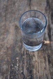 Photo of Glass of water outdoors, space for text