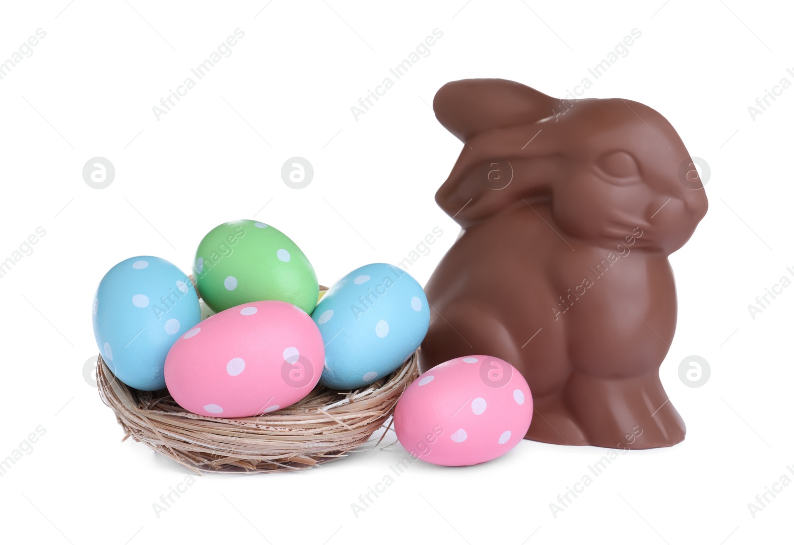 Photo of Chocolate Easter bunny and eggs on white background