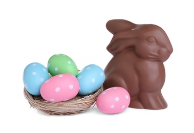 Photo of Chocolate Easter bunny and eggs on white background