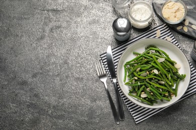 Photo of Tasty salad with green beans served on grey table, flat lay. Space for text