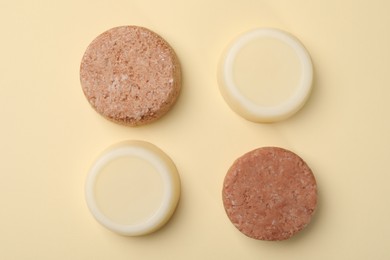 Photo of Flat lay composition with group of solid shampoo bars on beige background. Hair care