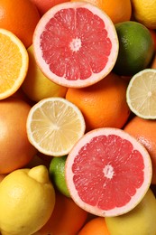 Photo of Different fresh citrus fruits as background, top view