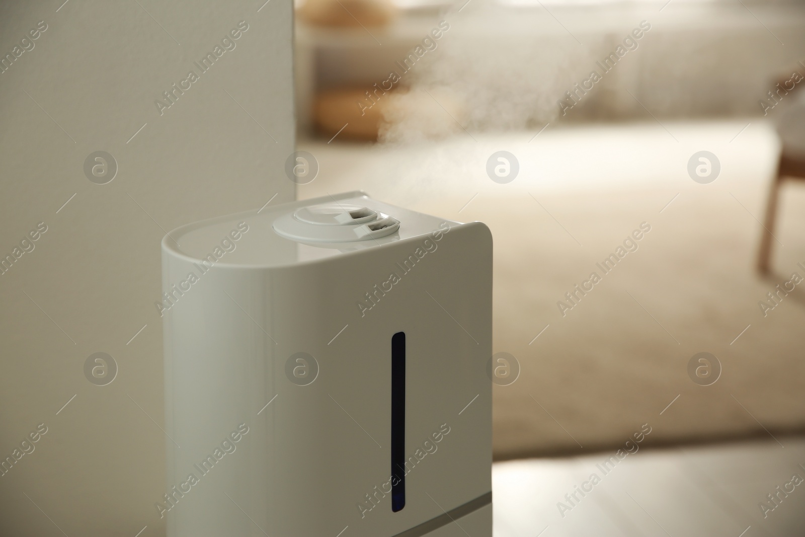 Photo of Modern humidifier in room. Space for text
