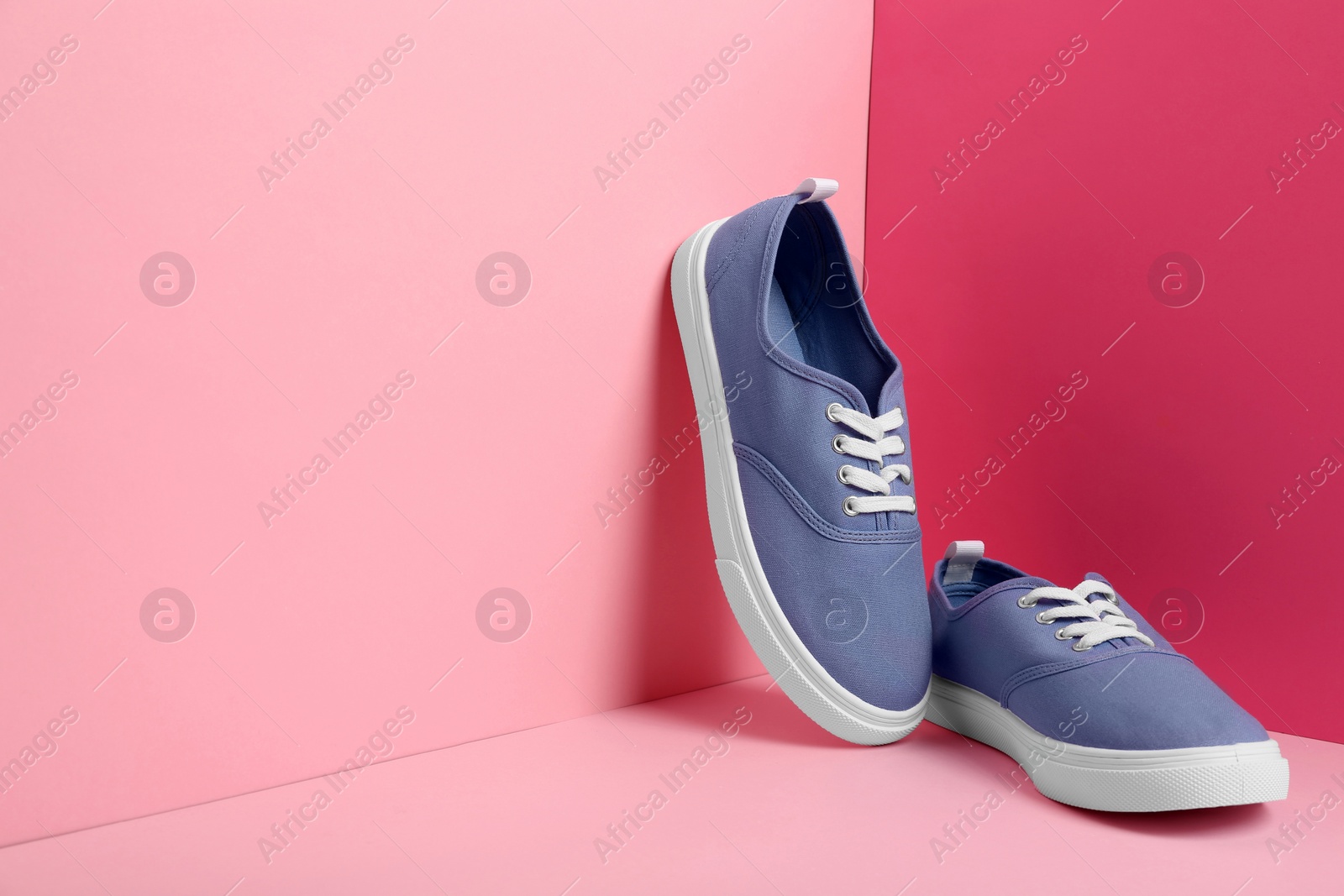 Photo of Comfortable sneakers on color background, space for text