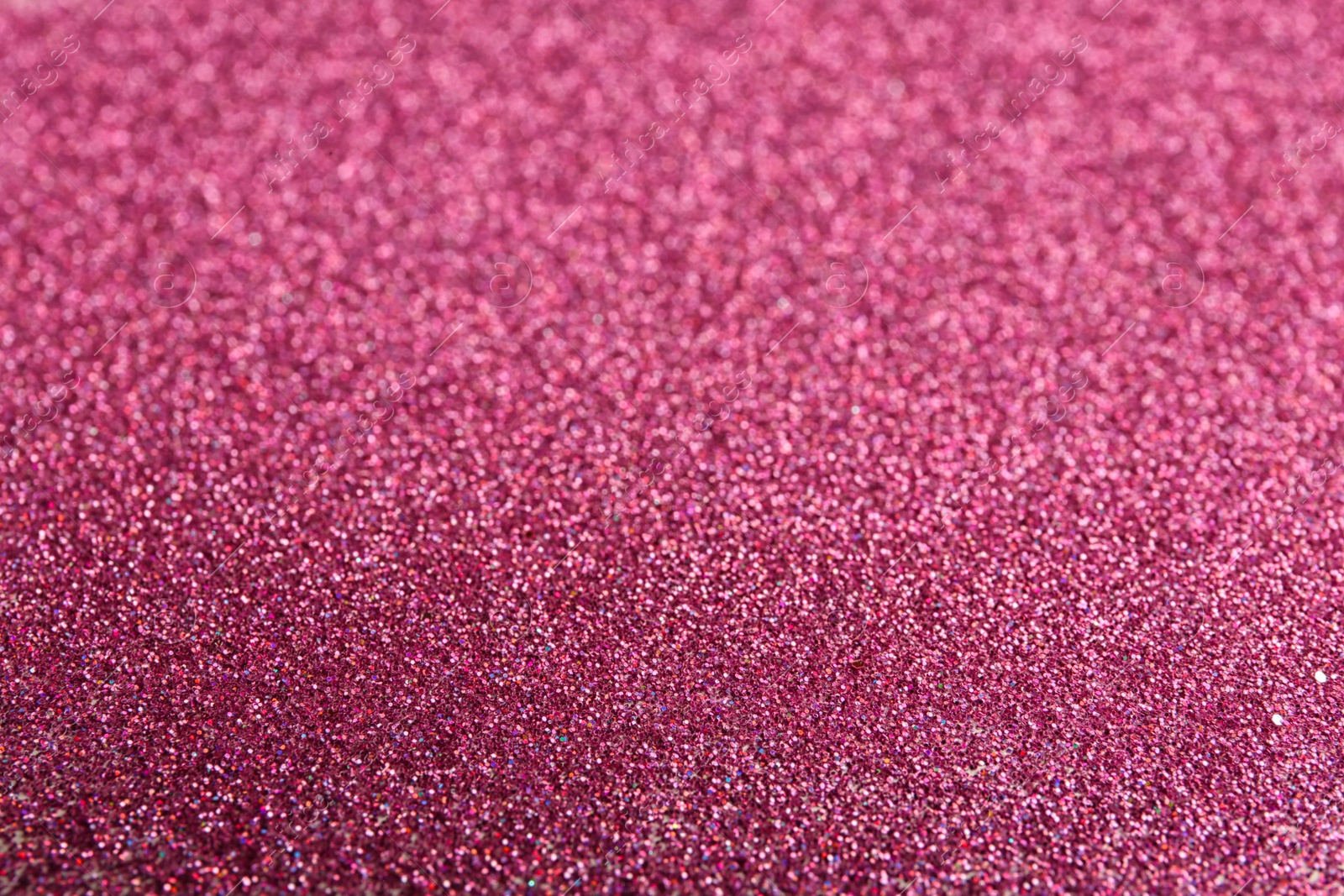 Photo of Closeup view of sparkling pink glitter background