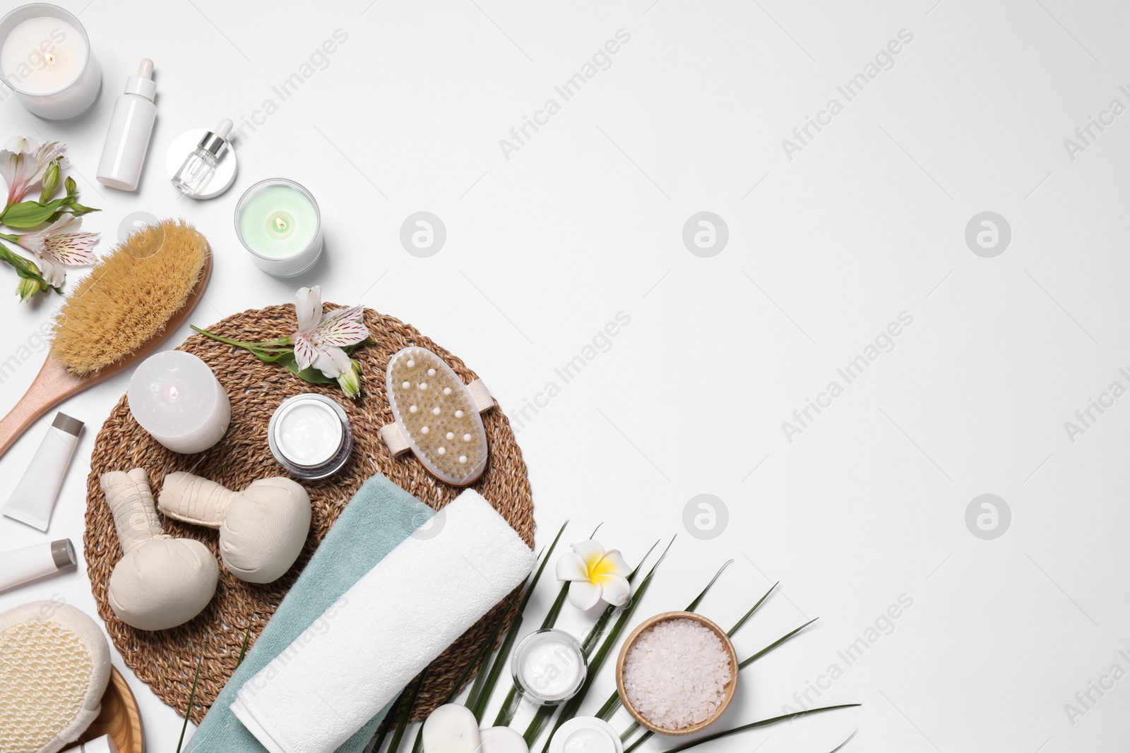 Photo of Flat lay composition with spa essentials on white background. Space for text