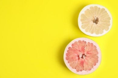 Photo of Fresh cut pomelo fruits on yellow background, flat lay. Space for text