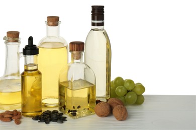 Vegetable fats. Different cooking oils and ingredients on wooden table against white background