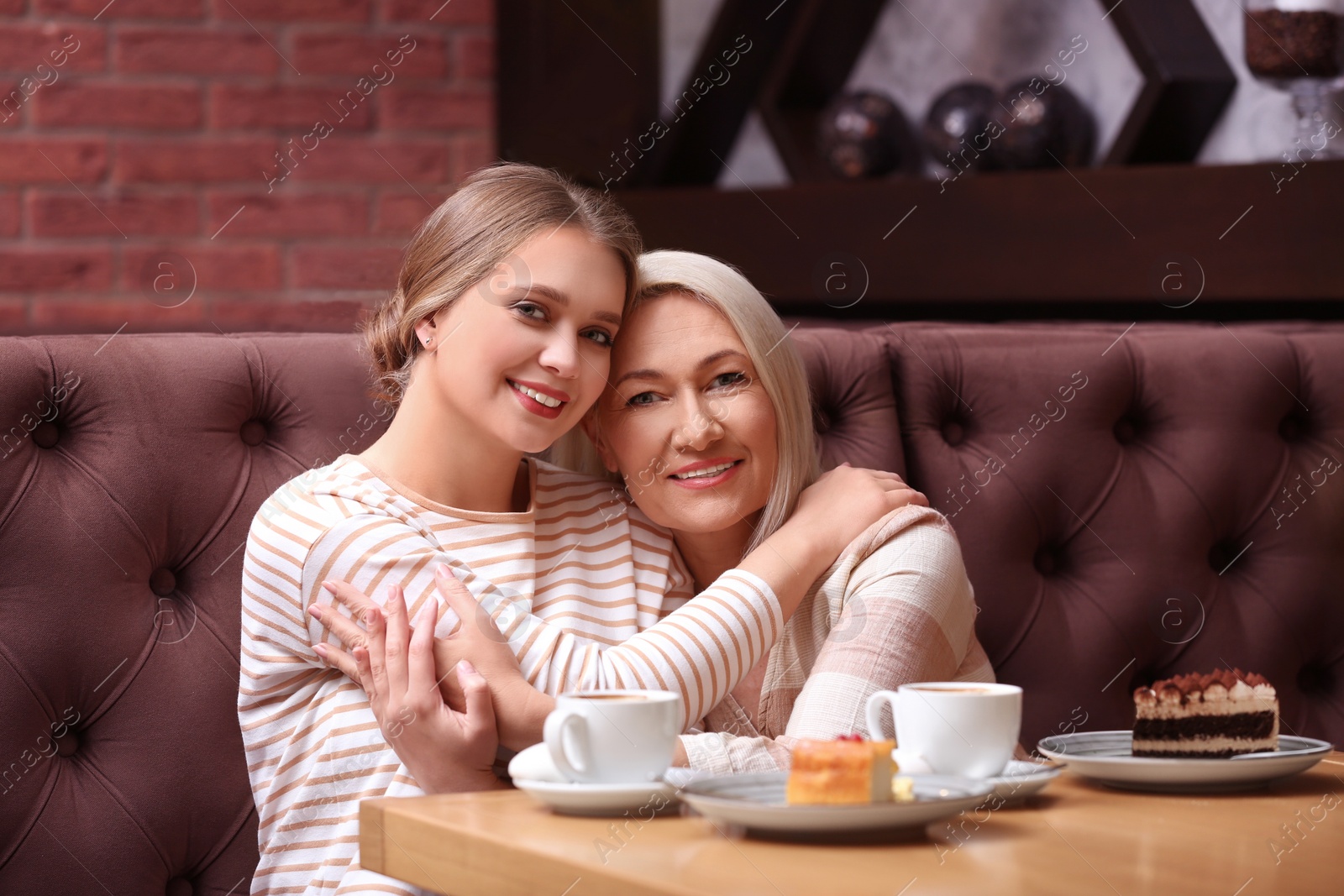 Photo of Mother and her adult daughter spending time together in cafe