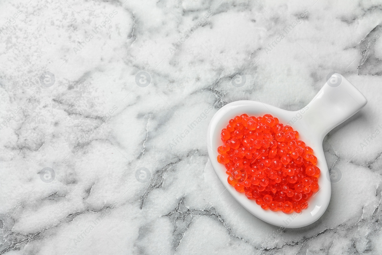 Photo of Dish with delicious red caviar on light background