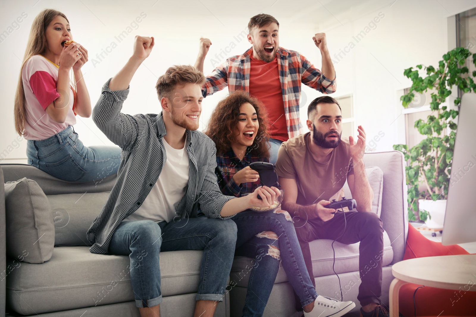 Photo of Emotional friends playing video games at home