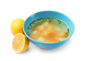Photo of Bowl of fresh homemade soup to cure flu and lemons on white background
