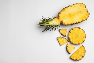 Composition with raw cut pineapple on white background, top view