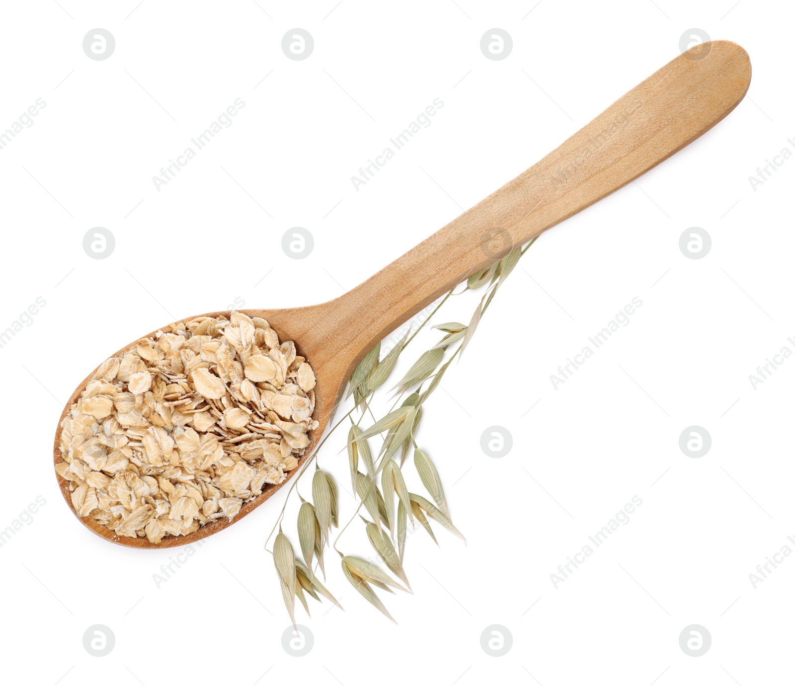 Photo of Wooden spoon of oatmeal and branch with florets isolated on white, top view