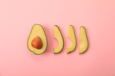 Photo of Flat lay composition with avocado slices on pink background