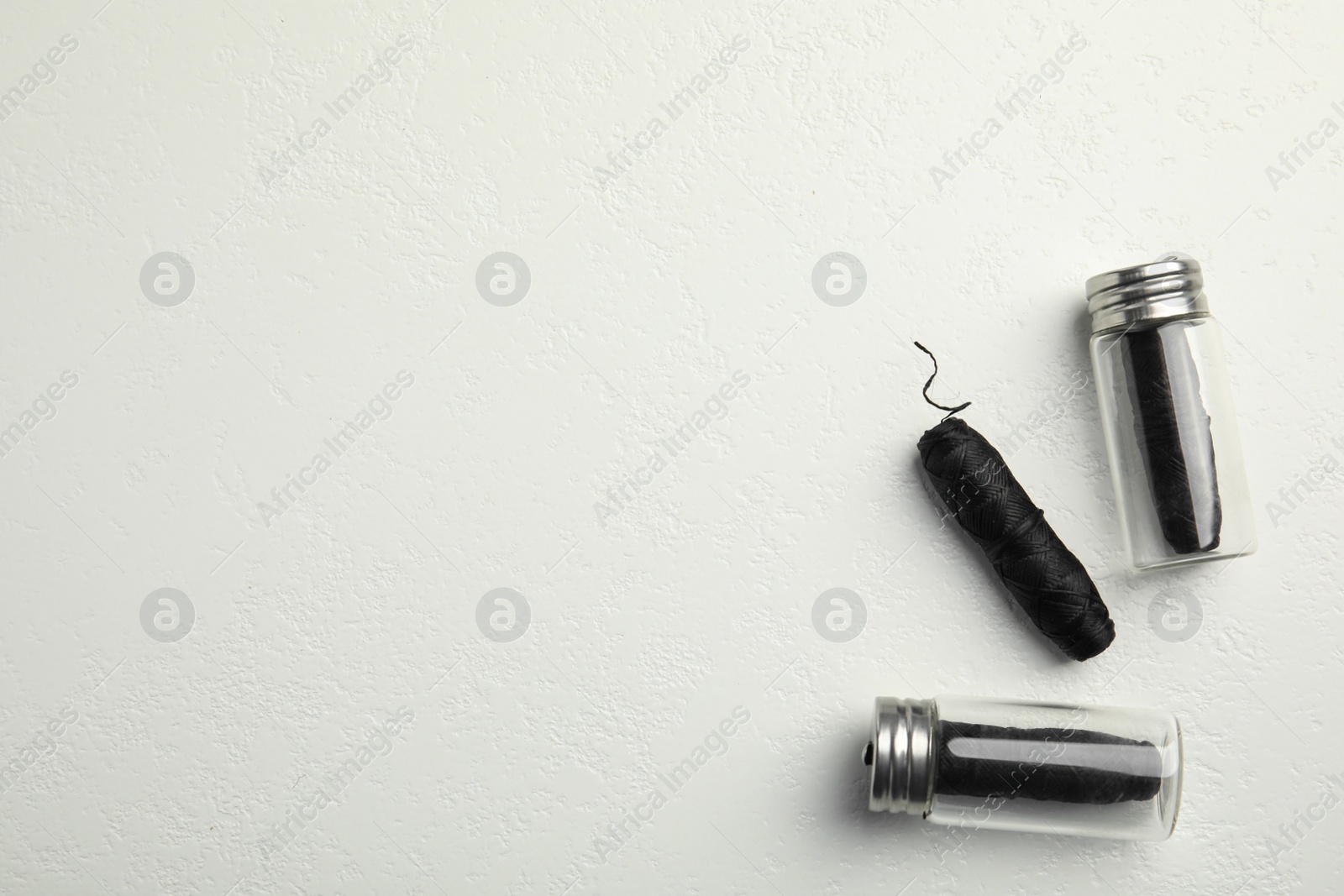 Photo of Biodegradable dental flosses on white background, flat lay. Space for text
