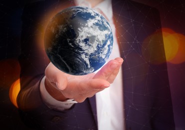 World in our hands. Woman holding digital model of Earth, closeup view 