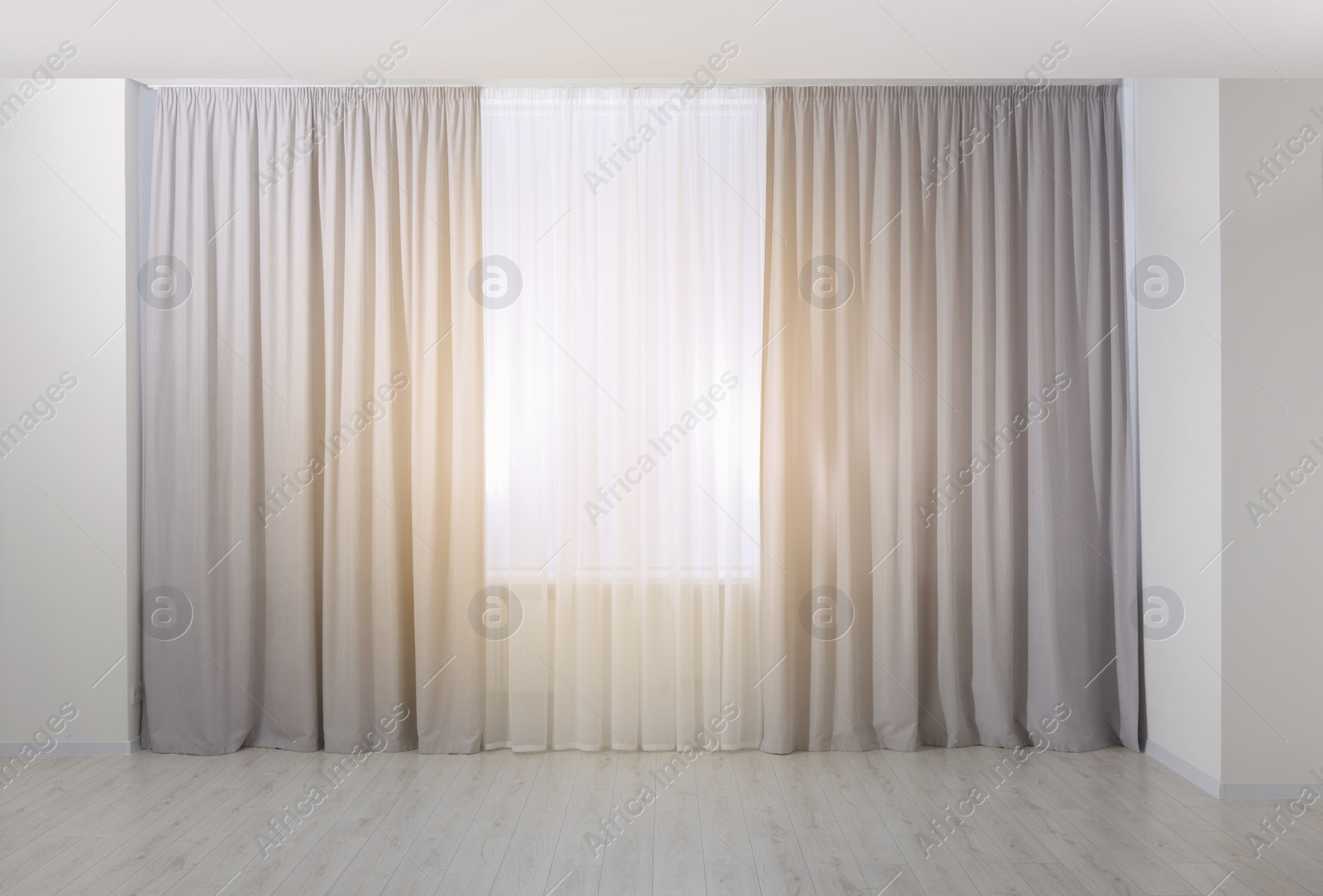 Photo of Light grey window curtains and white tulle indoors