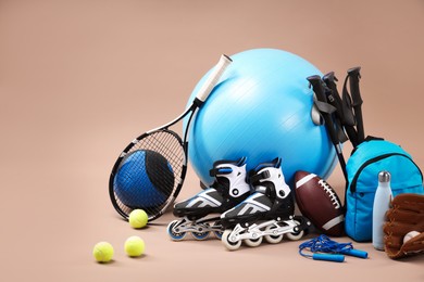 Photo of Many different sports equipment on beige background