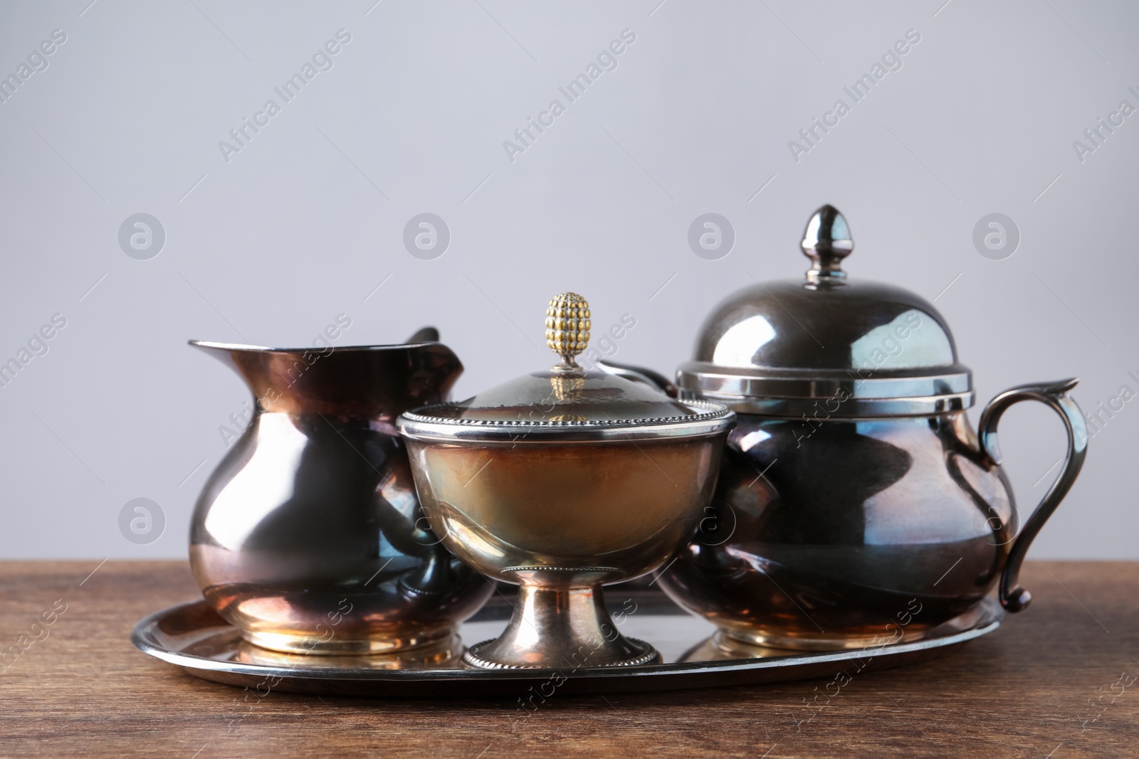 Photo of Tray with beautiful tea set on wooden table