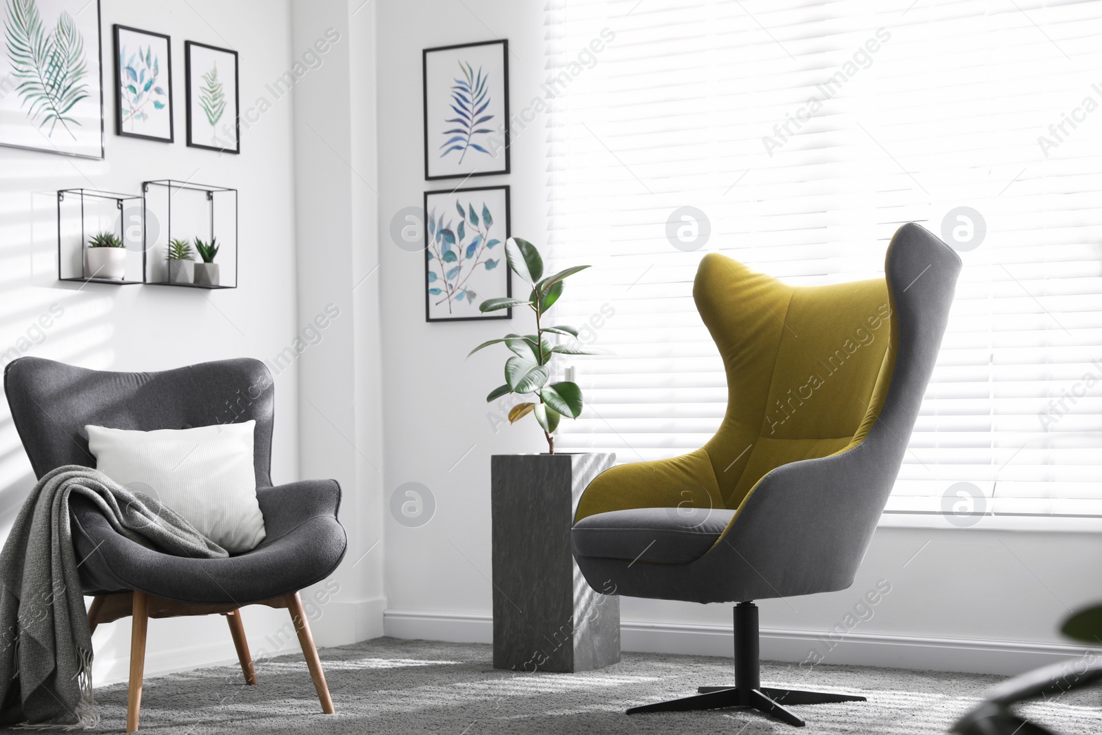 Photo of Comfortable armchairs near window in light room