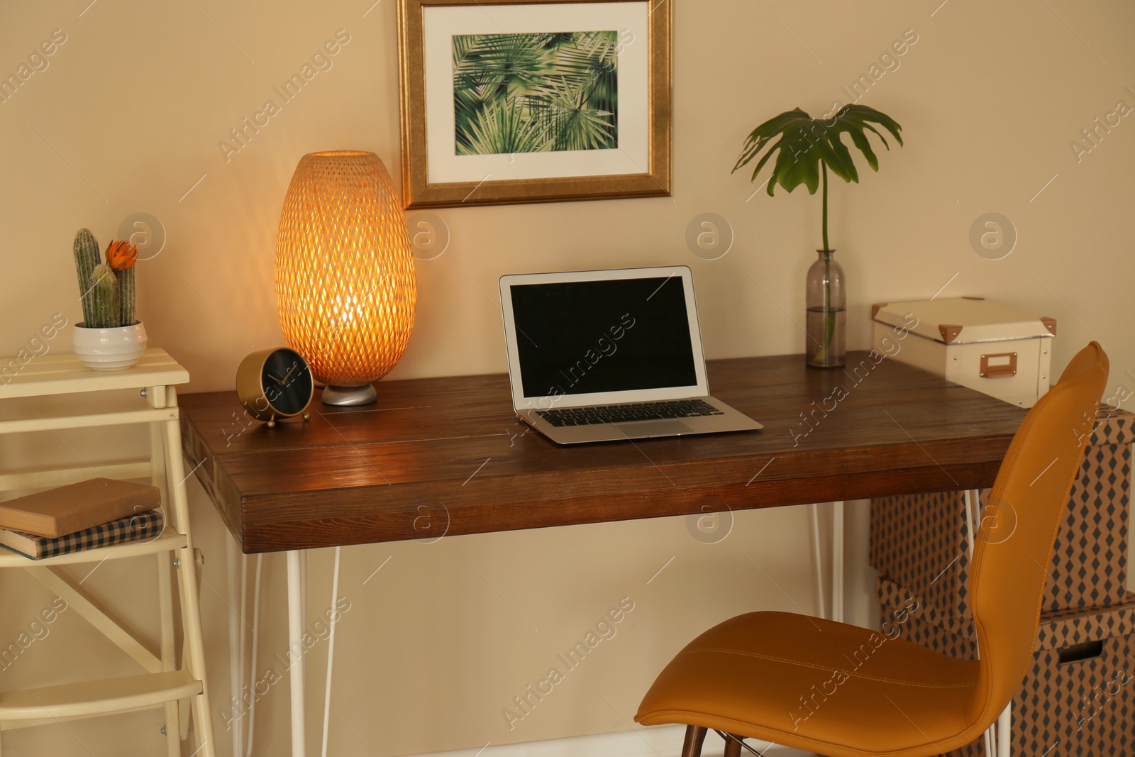 Photo of Stylish workplace with laptop on table in office