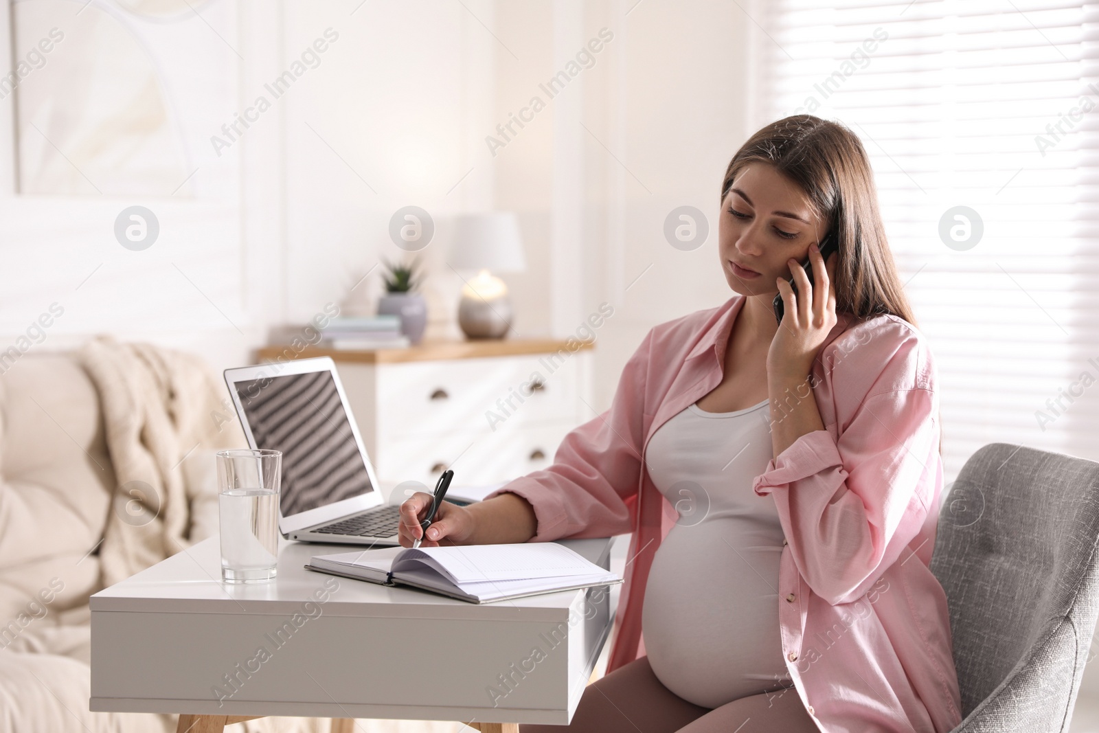 Photo of Pregnant woman working at home. Maternity leave