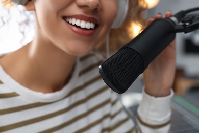 Photo of Woman working as radio host in modern studio, closeup