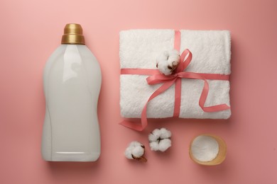 Photo of Flat lay composition with bottle of fabric softener on pink background