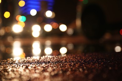 Photo of View of cityscape with bokeh effect, focus on asphalt. Night life