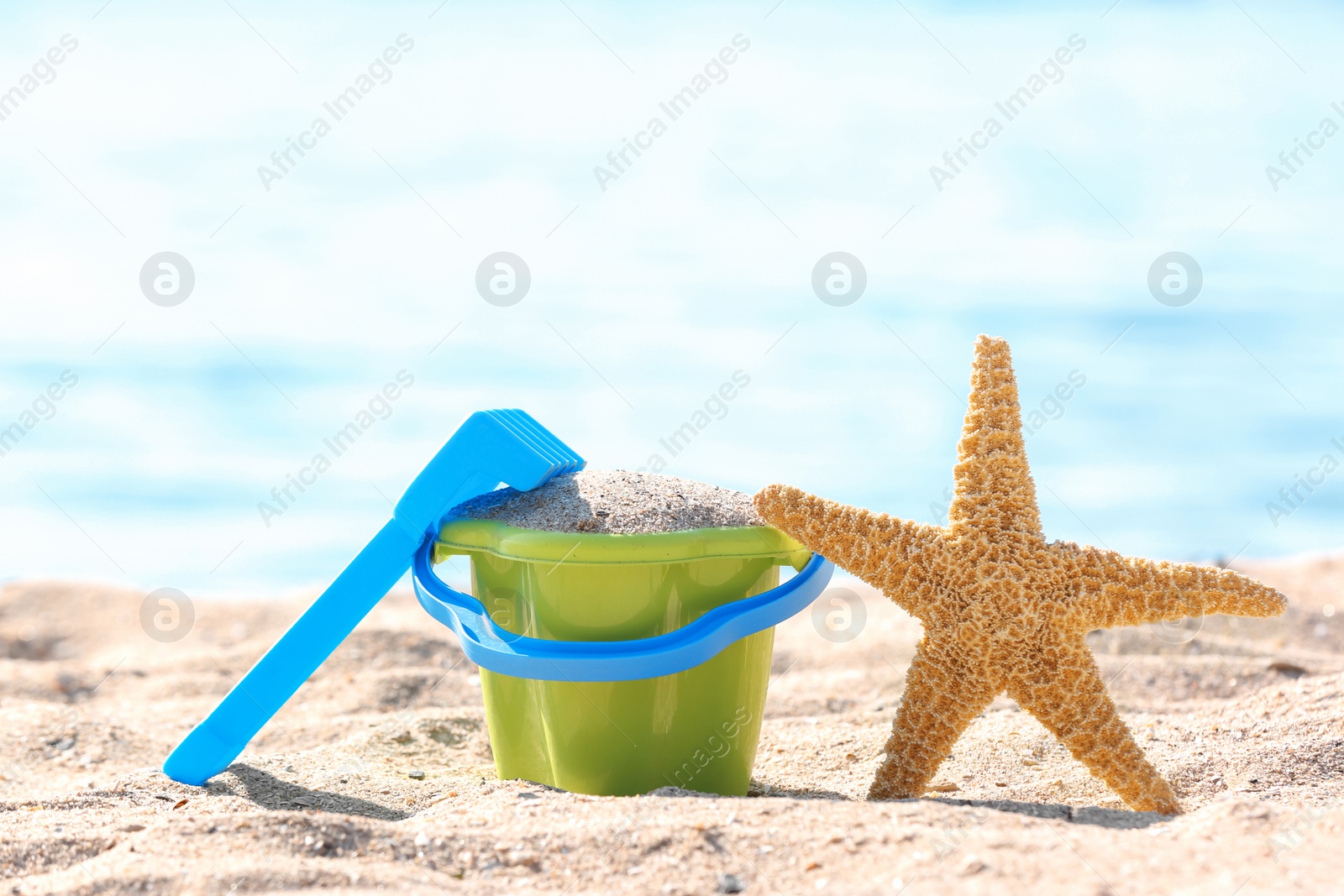 Photo of Children toys on sand near sea. Beach object