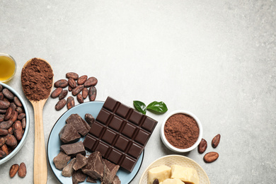 Flat lay composition with organic cocoa butter on light grey table. Space for text