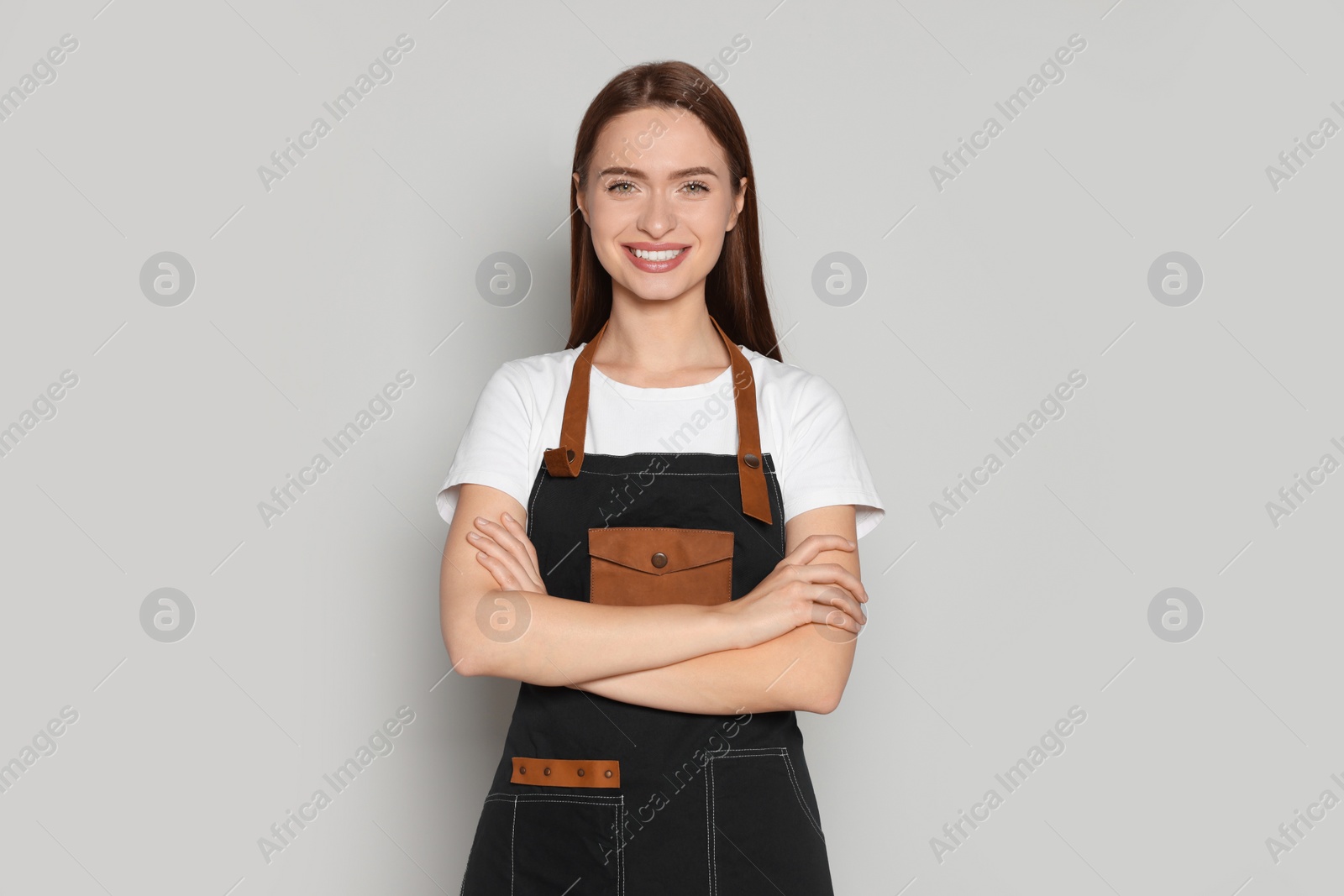 Photo of Portrait of happy hairdresser on light background