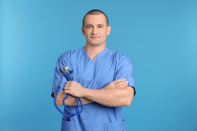 Photo of Portrait of medical assistant with stethoscope on color background