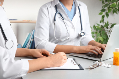 Photo of Doctors working at desk in office, closeup. Medical service