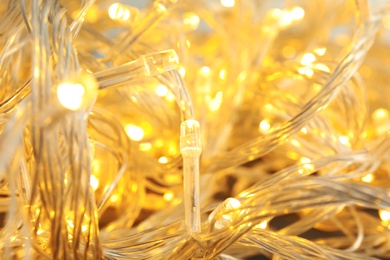 Photo of Glowing Christmas lights, closeup. Beautiful festive illumination