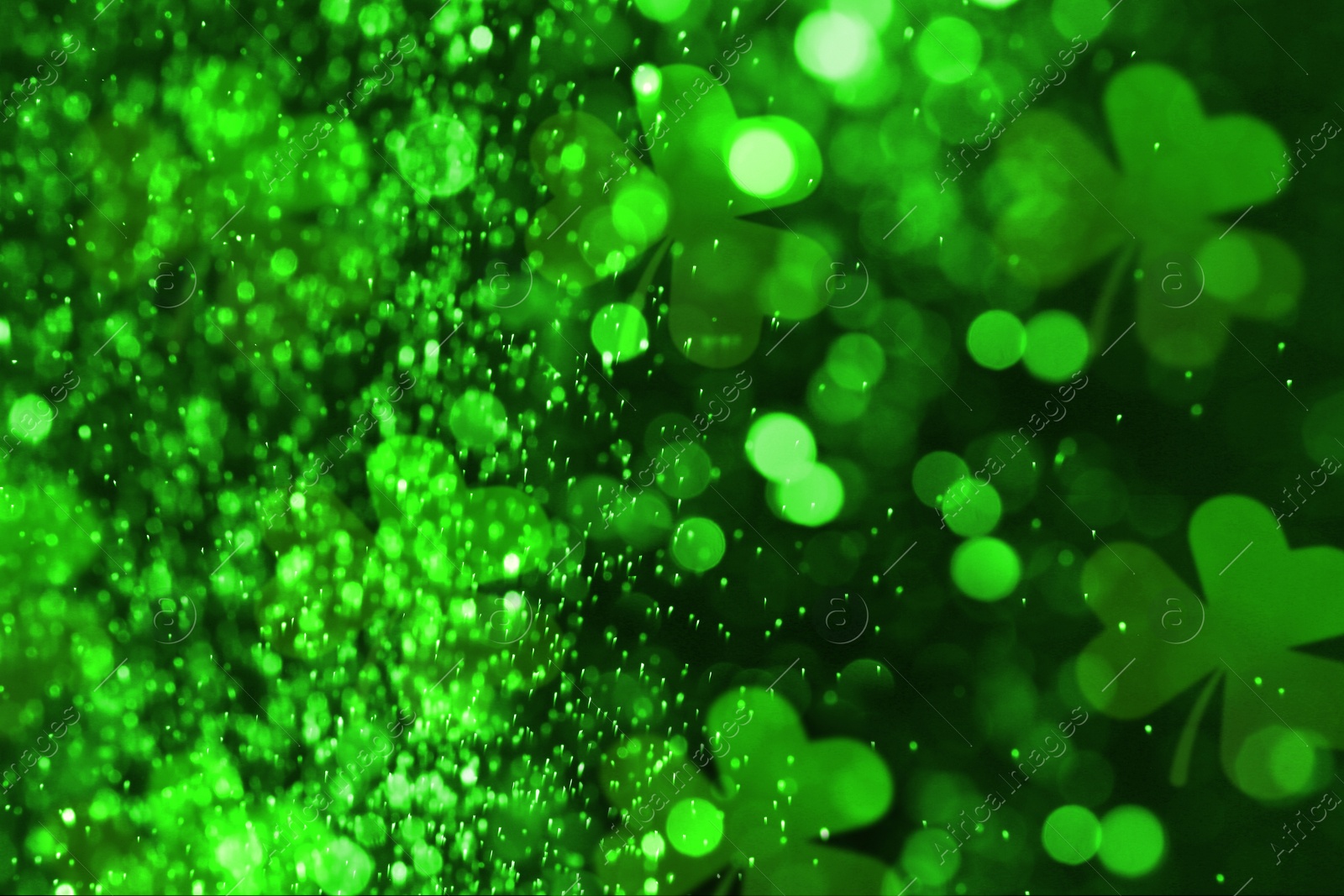 Image of St. Patrick's Day celebration. Clover leaves on dark background, bokeh effect