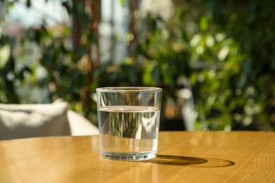 Photo of Glass of fresh water on wooden table