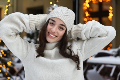 Portrait of smiling woman on city street in winter