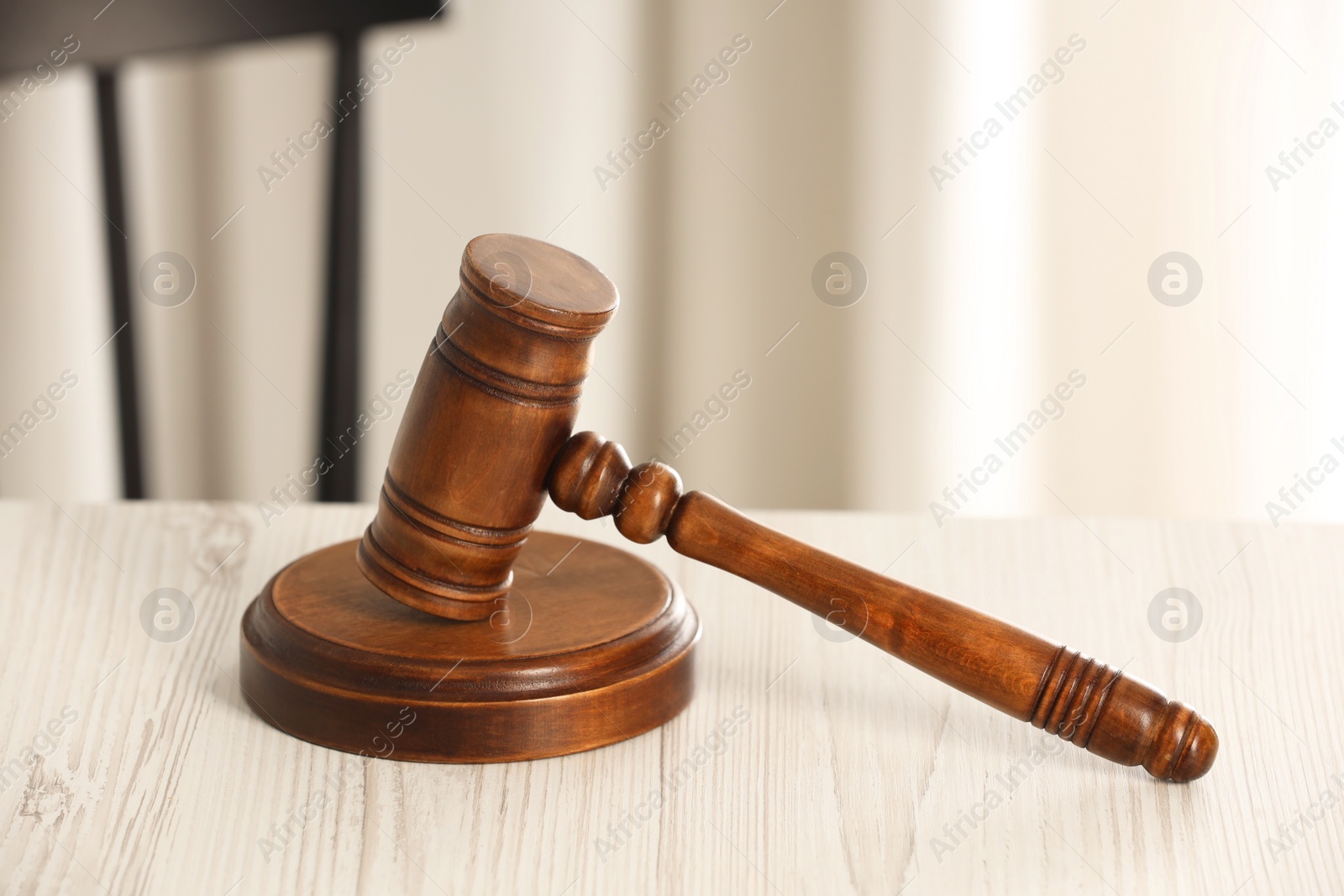 Photo of Law concept. Gavel on white wooden table