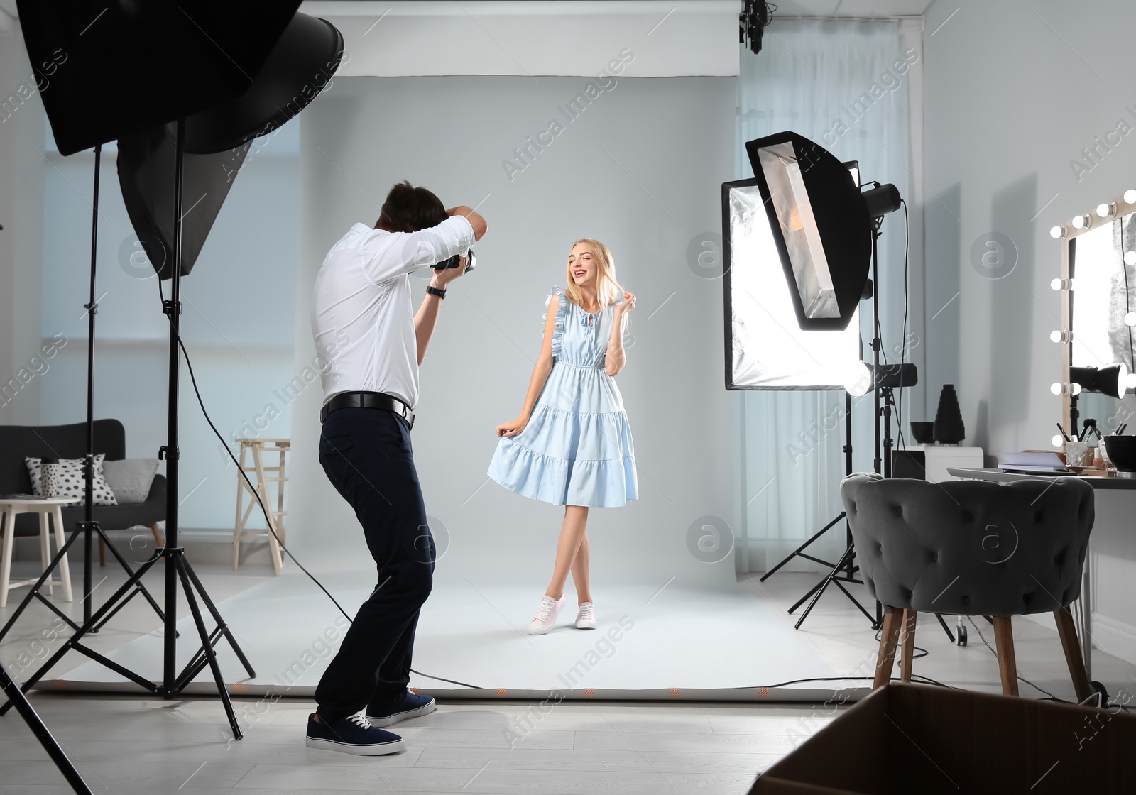 Photo of Beautiful model posing for professional photographer in studio