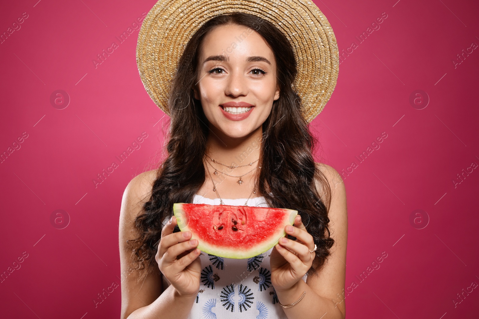 Photo of Beautiful young woman with watermelon on pink background