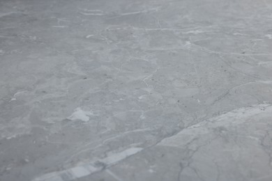 Photo of Texture of light grey marble surface as background, closeup
