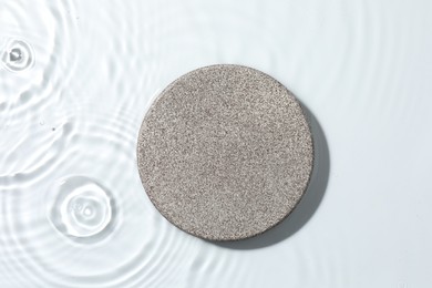 Photo of Presentation for product. Stone podium in water on white background, top view