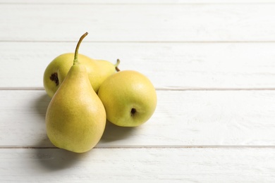 Ripe pears on wooden background. Space for text